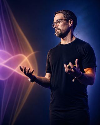 A speaker engages the audience with a dynamic presentation at the HOLOLIFE Summit 2026 in Amsterdam.