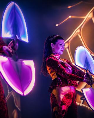 A performer captivating the audience with a vibrant light display at the HOLOLIFE Summit.