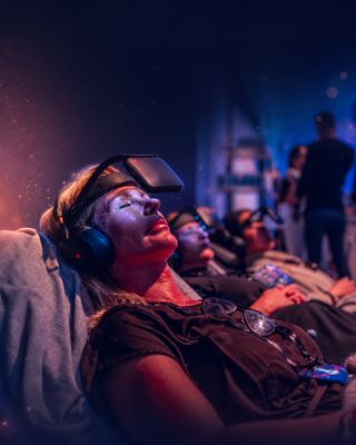 Attendees engage in immersive experiences using VR headsets, capturing the innovative spirit of the HOLOLIFE Summit.